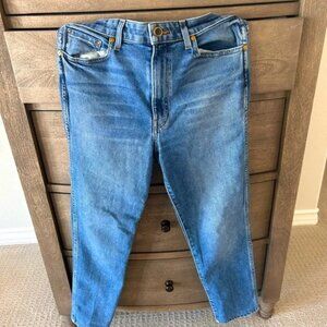 Khaite medium wash straight leg stretch jeans.